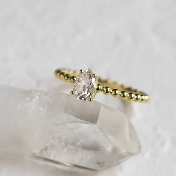 Gold engagement ring with beaded ball setting and pear moissanite BEAU Image