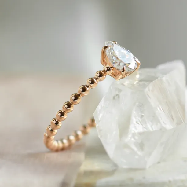 Gold engagement ring with beaded ball setting and pear moissanite BEAU Image