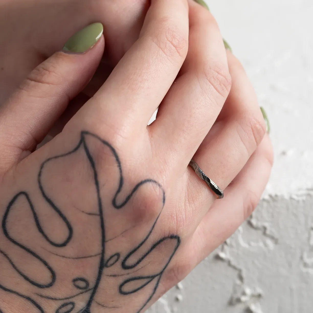 Black wedding ring on hand
