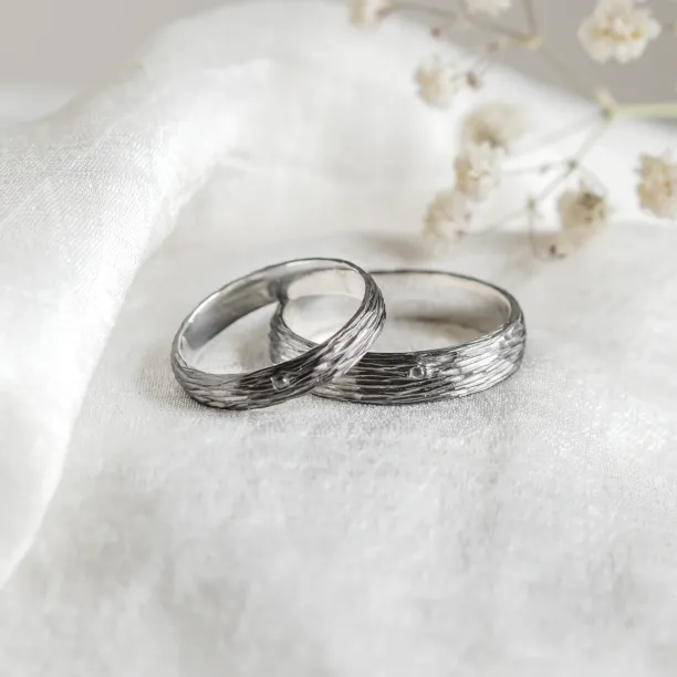 Black wedding rings with woodbark surface EBEN Image