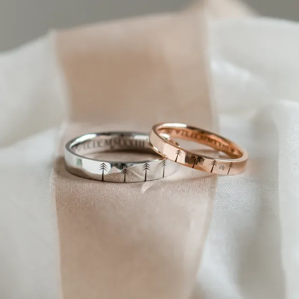 Gold wedding rings with engraved trees FORI Image