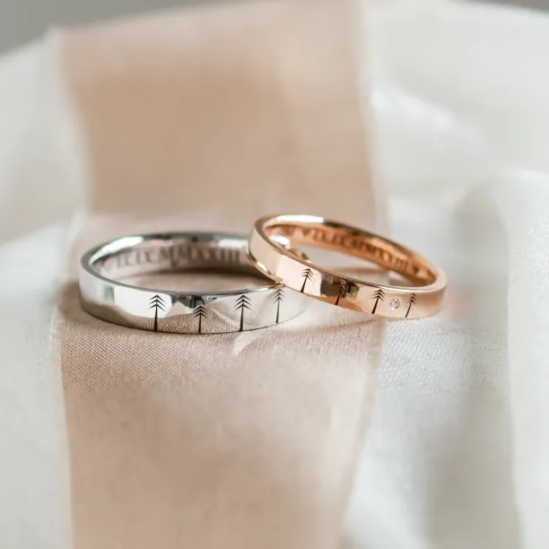 Gold wedding rings with engraved trees FORI Image