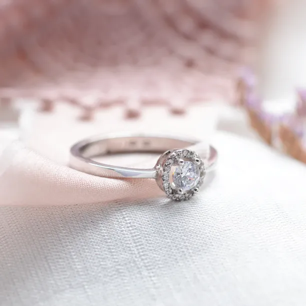 A gold ring with halo stones and diamonds HALOY Image