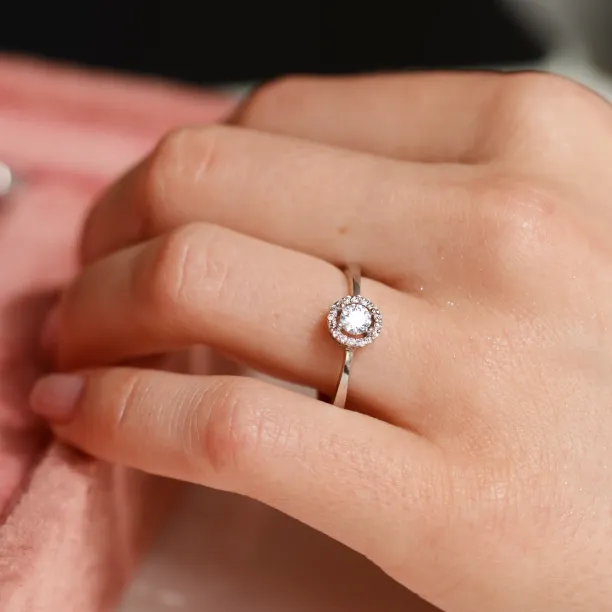 A gold ring with halo stones and diamonds HALOY Image