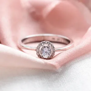 A gold ring with halo stones and diamonds HALOY