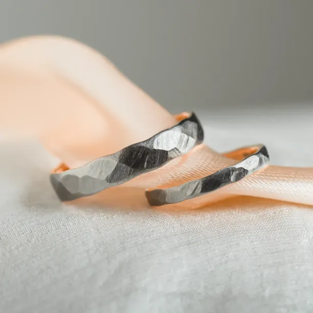 Black wedding bands in gold with hammered surface AZTEK Image