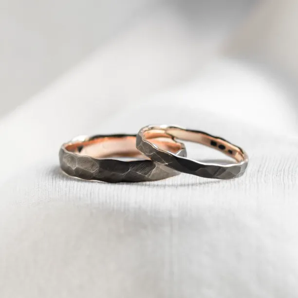 Black wedding bands in gold with hammered surface AZTEK Image