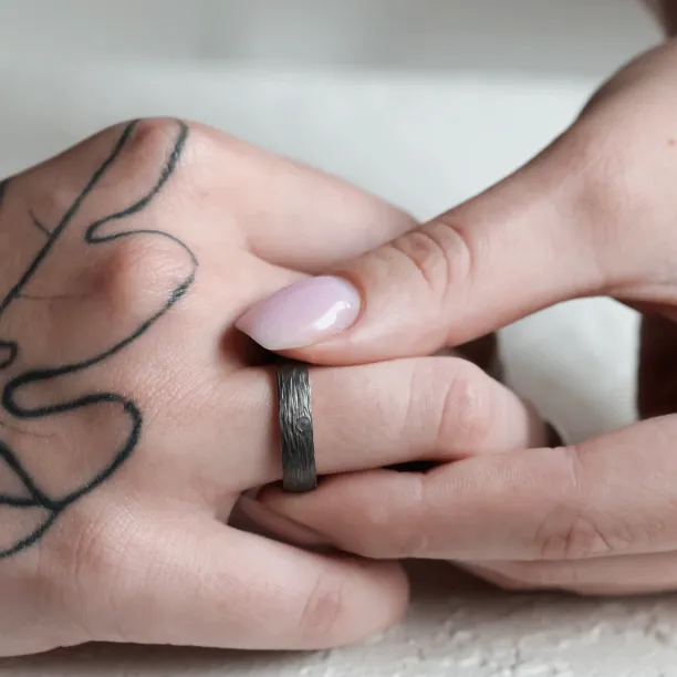 Black wedding rings with woodbark surface EBEN Image