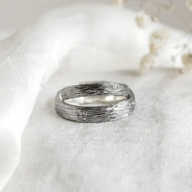 Black wedding rings with woodbark surface EBEN Image