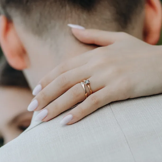 Wavy gold wedding rings with a diamond APRILIA Image
