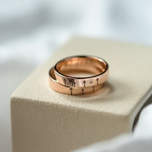 Gold wedding rings with engraved trees FORI Image