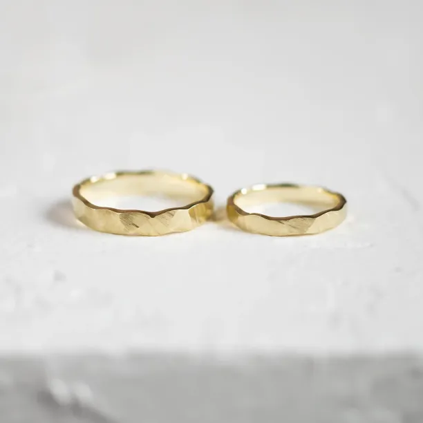 Gold wedding rings with a relief surface TRINVI Image