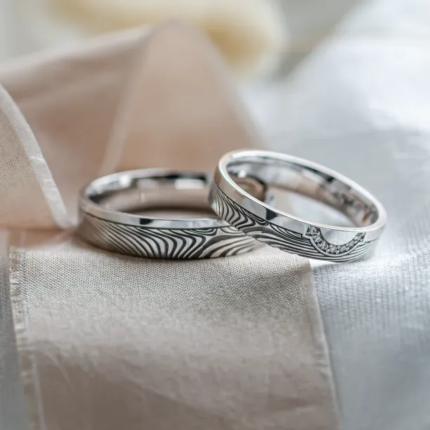 Wedding rings with abstract relief and diamonds OMEGA Image