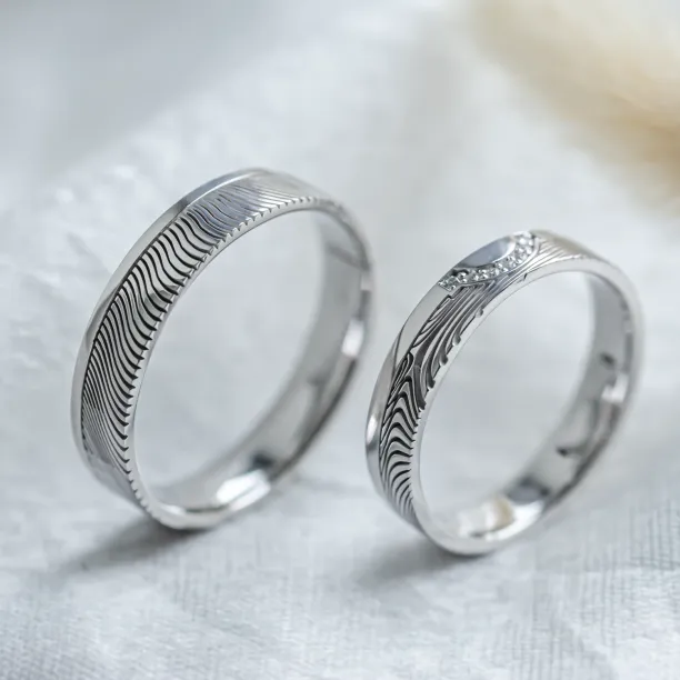 Wedding rings with abstract relief and diamonds OMEGA Image