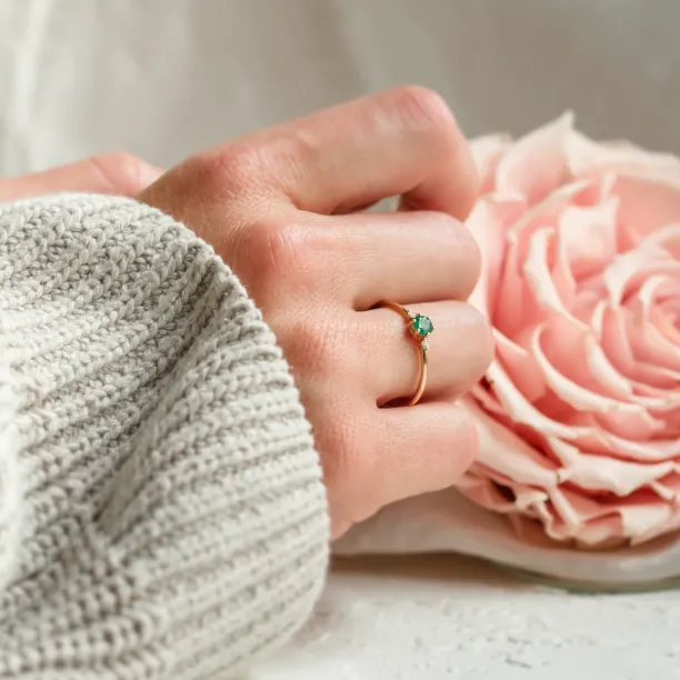 Engagement ring with emerald and side diamonds AVA Image