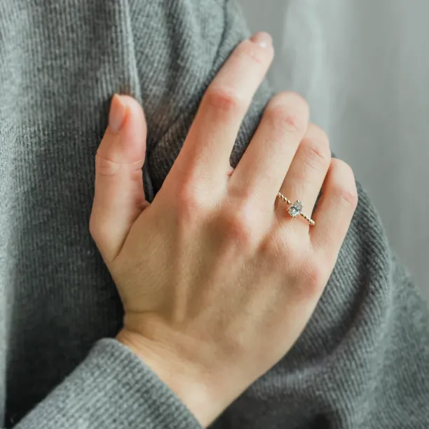 Gold engagement ring with beaded ball setting and pear moissanite BEAU Image
