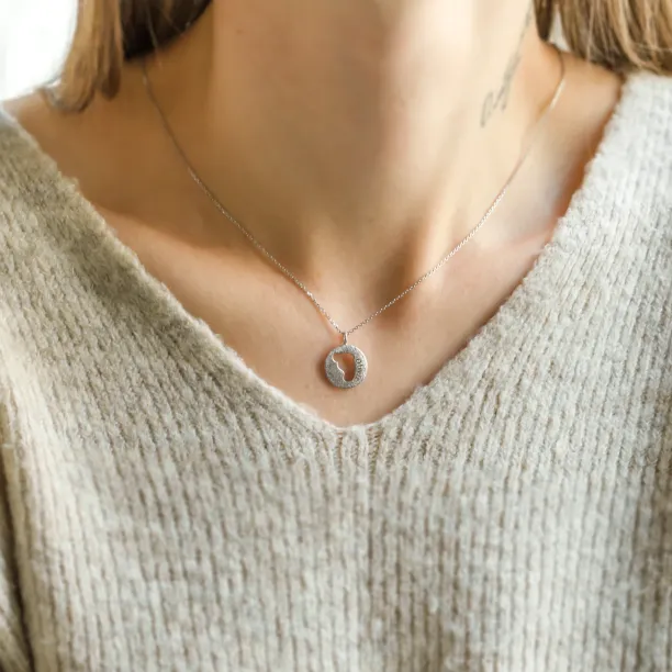 Gold necklace with unusual surface and baby foot trace LEE Image