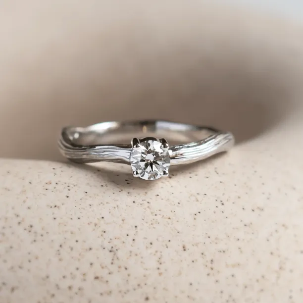 Atypical engagement ring with diamond and tree bark surface RIA Image
