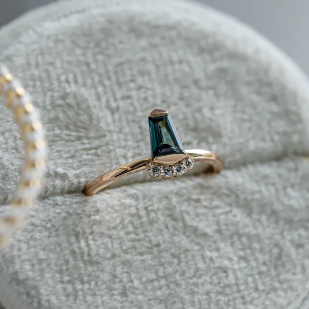 Unusual gold ring with teal sapphire and side diamonds AZRAQ Image