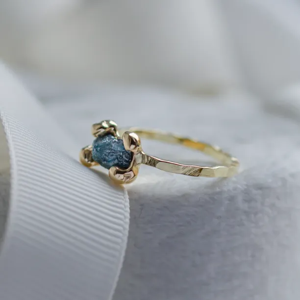 Gold ring with blue raw diamond and hammered surface SEA Image