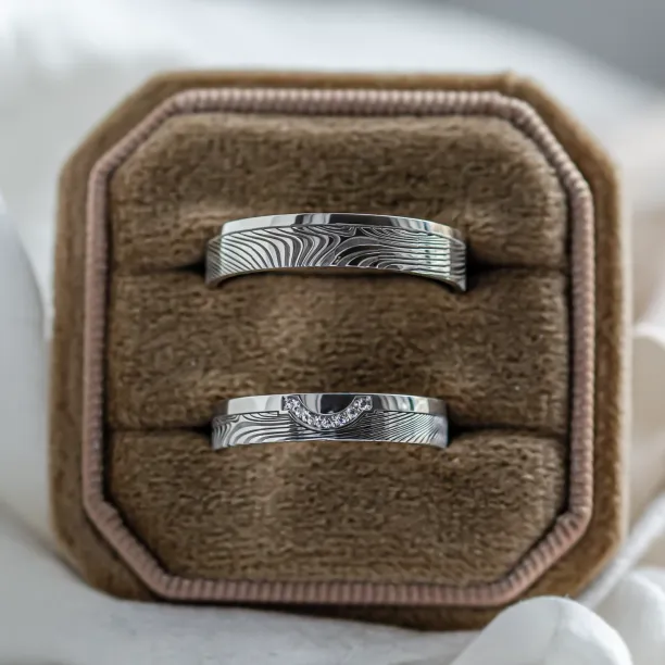 Wedding rings with abstract relief and diamonds OMEGA Image