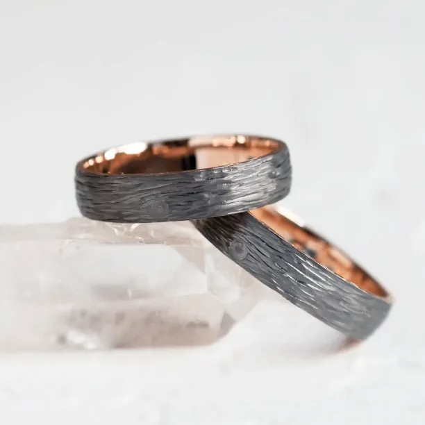 Black wedding rings with woodbark surface EBEN Image