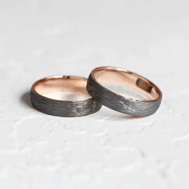 Black wedding rings with woodbark surface EBEN Image