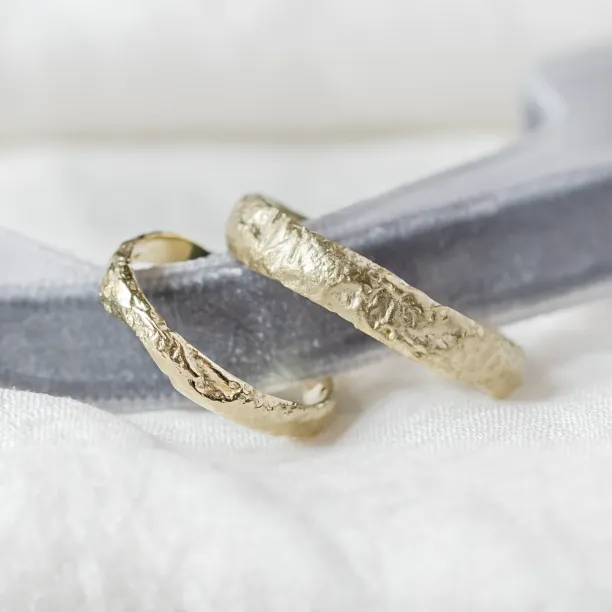 Gold wedding bands with moon surface APOLLO Image