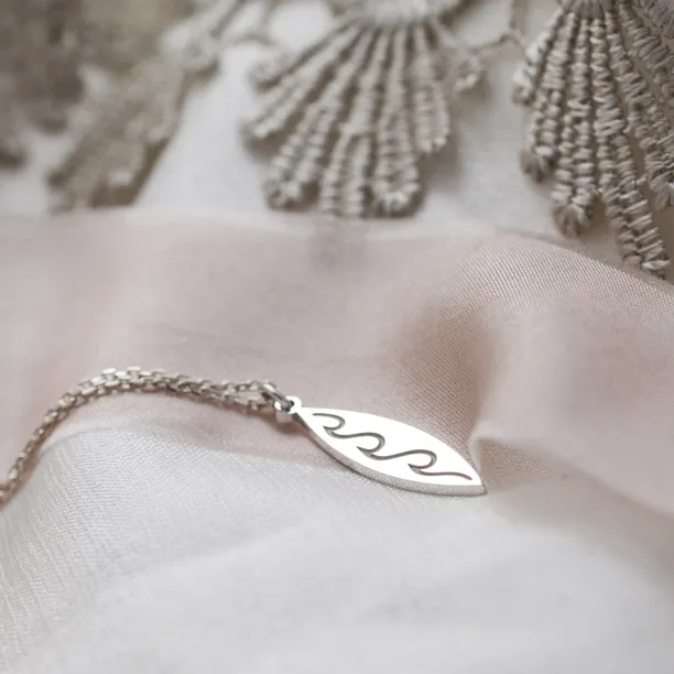 Silver pendant with engraving of waves  ALOHA Image
