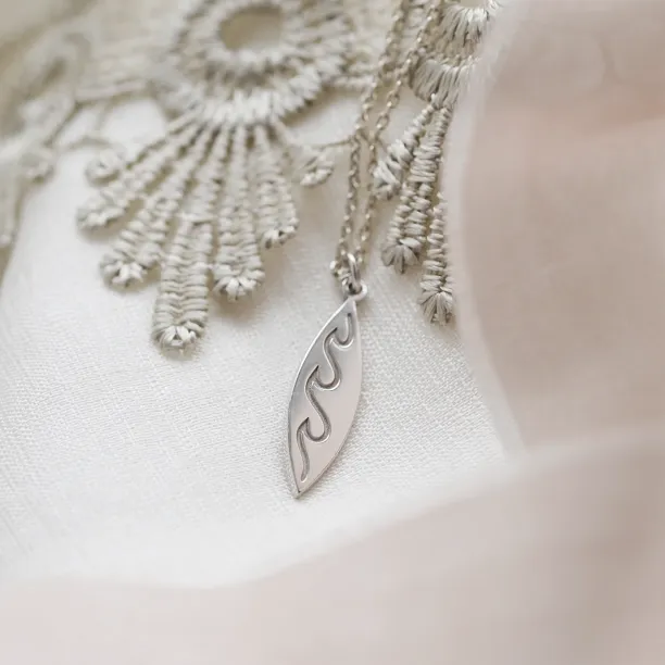 Silver pendant with engraving of waves  ALOHA Image