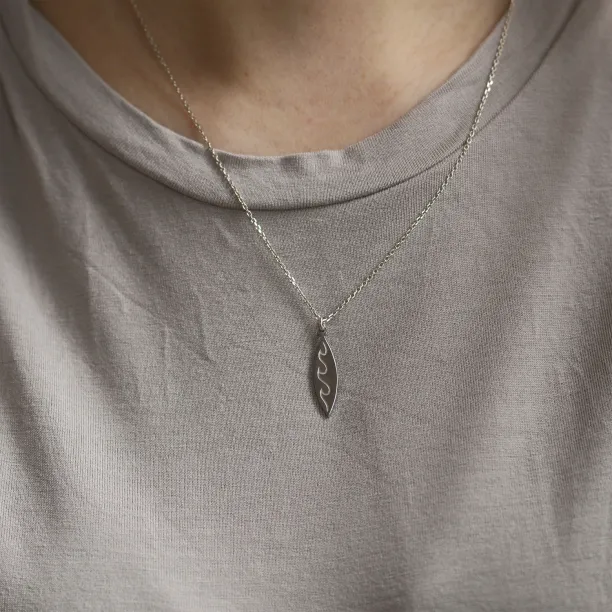 Silver pendant with engraving of waves  ALOHA Image