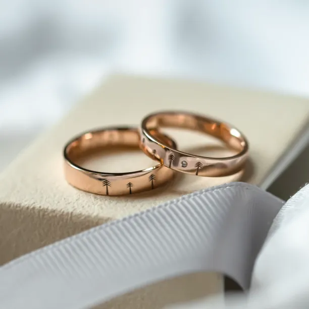 Gold wedding rings with engraved trees FORI Image