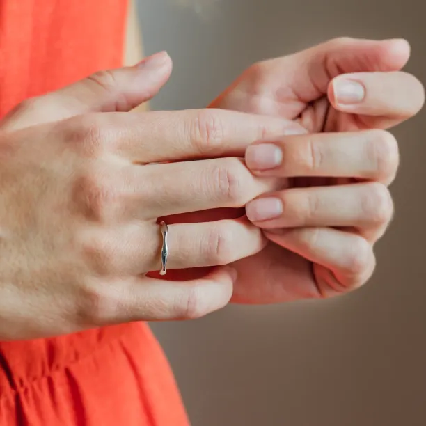 Wavy gold wedding rings with a diamond APRILIA Image