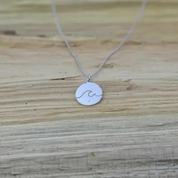 Gold pendant with a diamond SURF Image