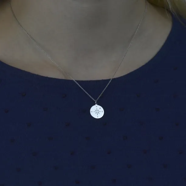 Silver pendant with a compass and a diamond MAP Image