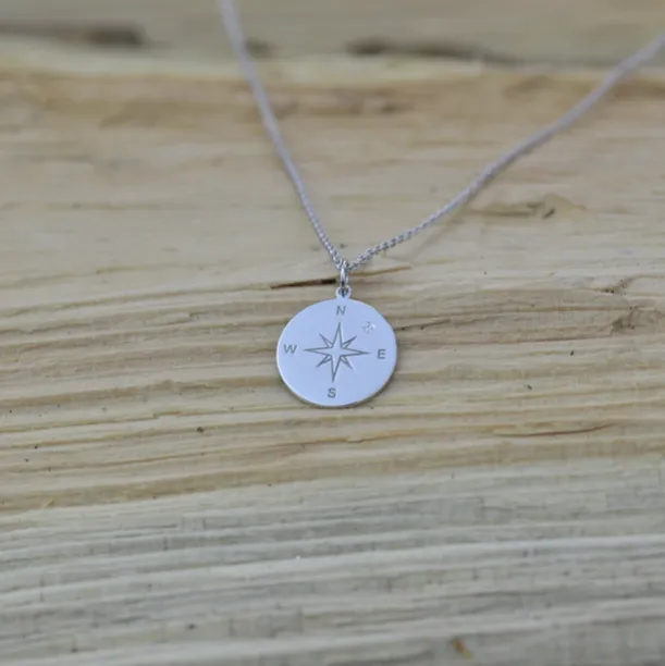 Silver pendant with a compass and a diamond MAP Image