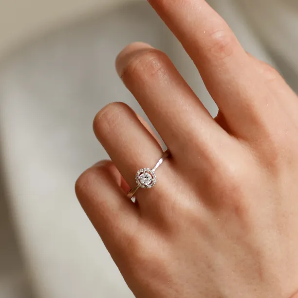 A gold ring with halo stones and diamonds HALOY Image