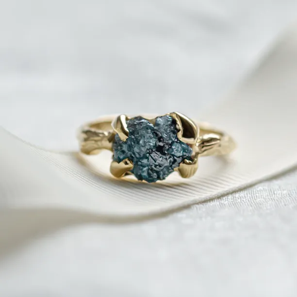 Gold ring with blue raw diamond and unusual rim SKY Image